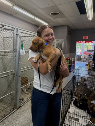 Adcom employee holding a dog